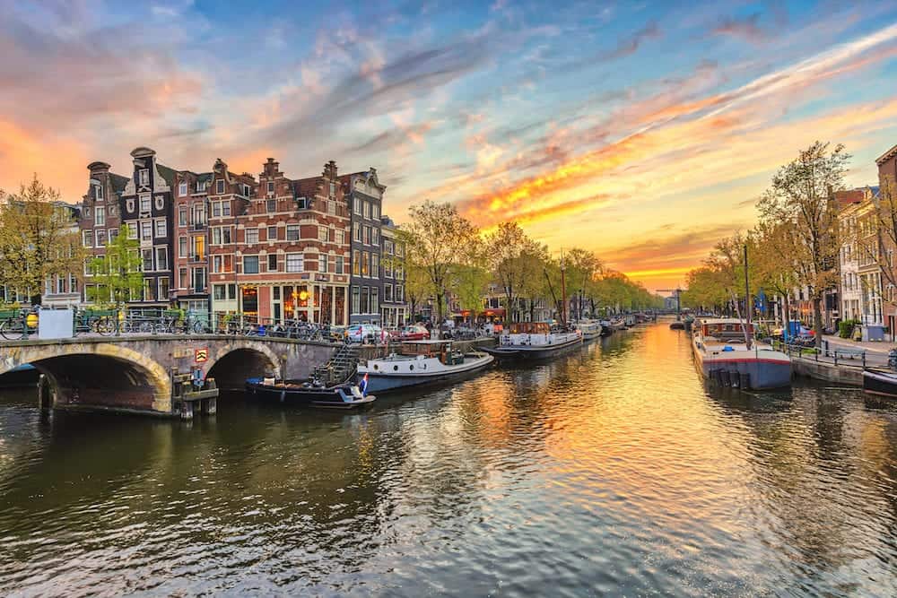 Amsterdam sunset city skyline at canal waterfront Amsterdam Netherlands