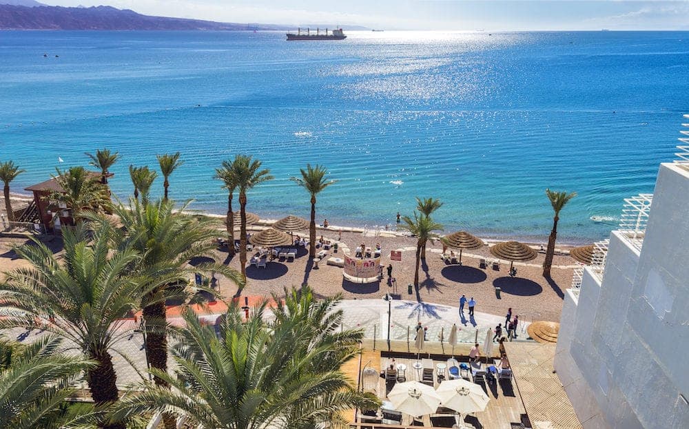 EILAT, ISRAEL - Aerial view on the Red Sea, central public beach and promenade in Eilat - famous vacation spot, resort and recreational city in Israel and Middle East