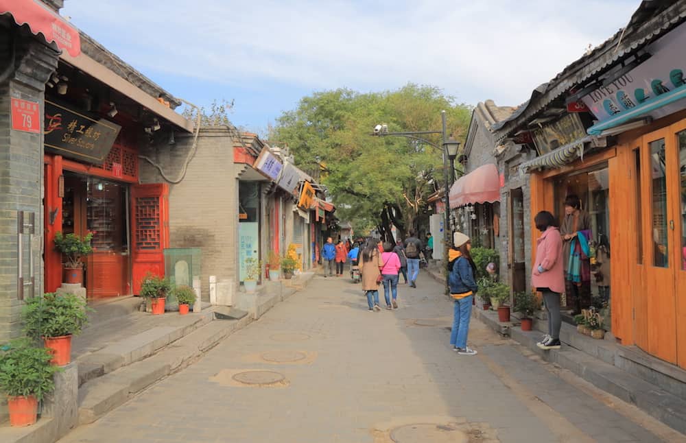 Pequim CHINA - pessoas não identificadas visitam a rua Nanluoguxiang futong. Nanluoguxiang lane tornou-se um destino turístico popular com restaurantes e bares.