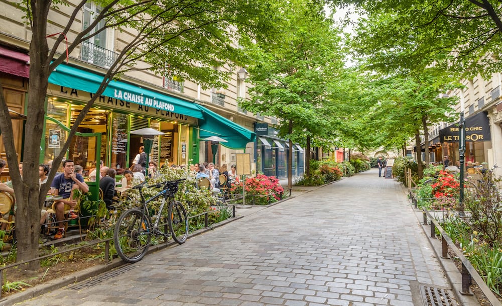 Paris, France - A quiet street with restaurants in the bohemian Marais district of Paris
