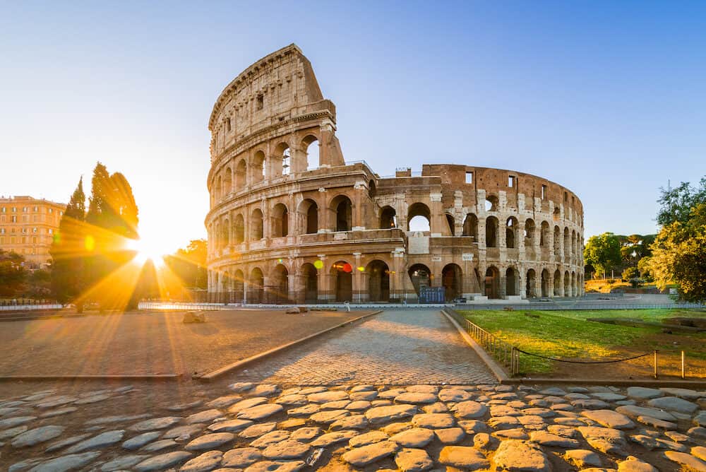 Colosseum at sunrise, Rome, Italy, Europe. Rome ancient arena of gladiator fights. Rome Colosseum is the best known landmark of Rome and Italy