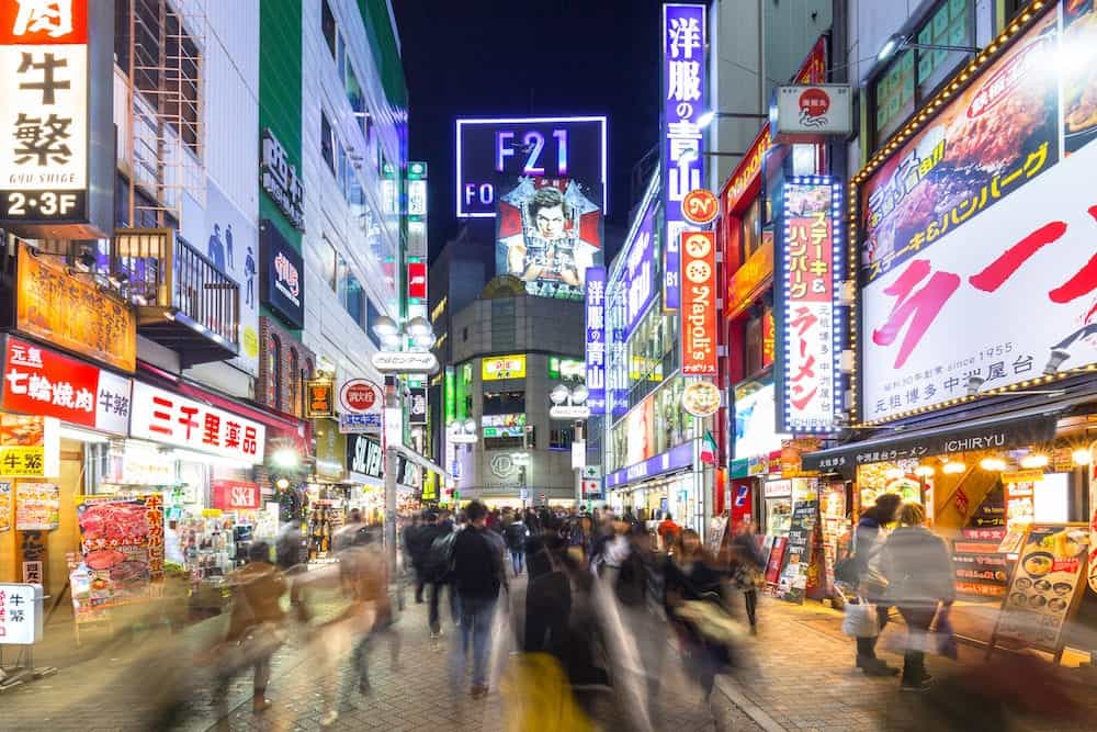 TOKYO, JAPAN - : Busy streets of Shibuya district in Tokyo at night, Japan. Shibuya is the shopping district which surrounds Shibuya Station, one of Tokyo's busiest railway stations.