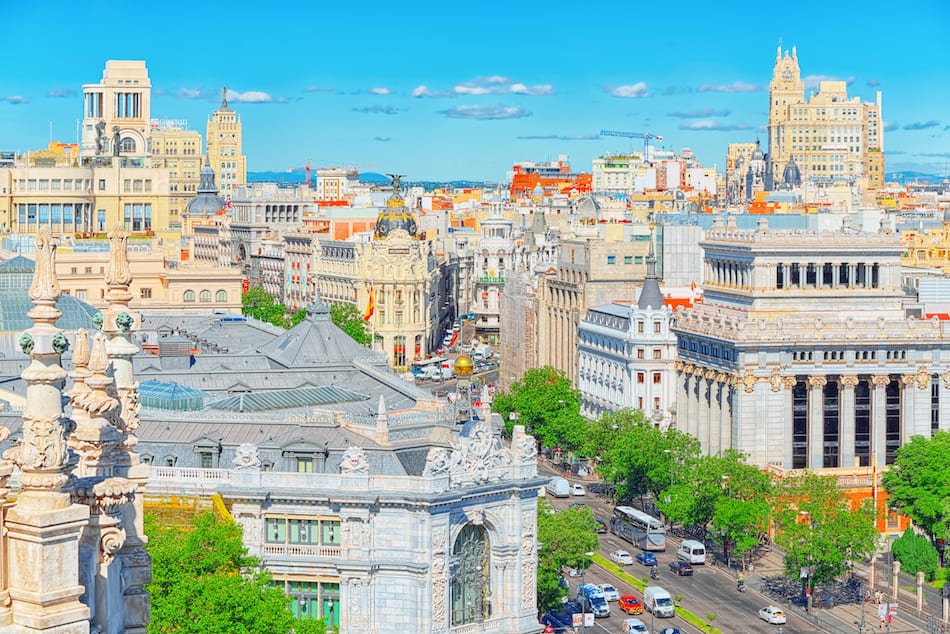 View above on Gran Via Street in Madrid at day time traffic car on Gran Via street main shopping and financial street in capital of Spain. Madrid.