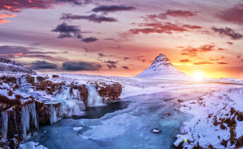 Kirkjufell mountain with frozen water falls in winter, Iceland. One of the famous natural heritage in Iceland.