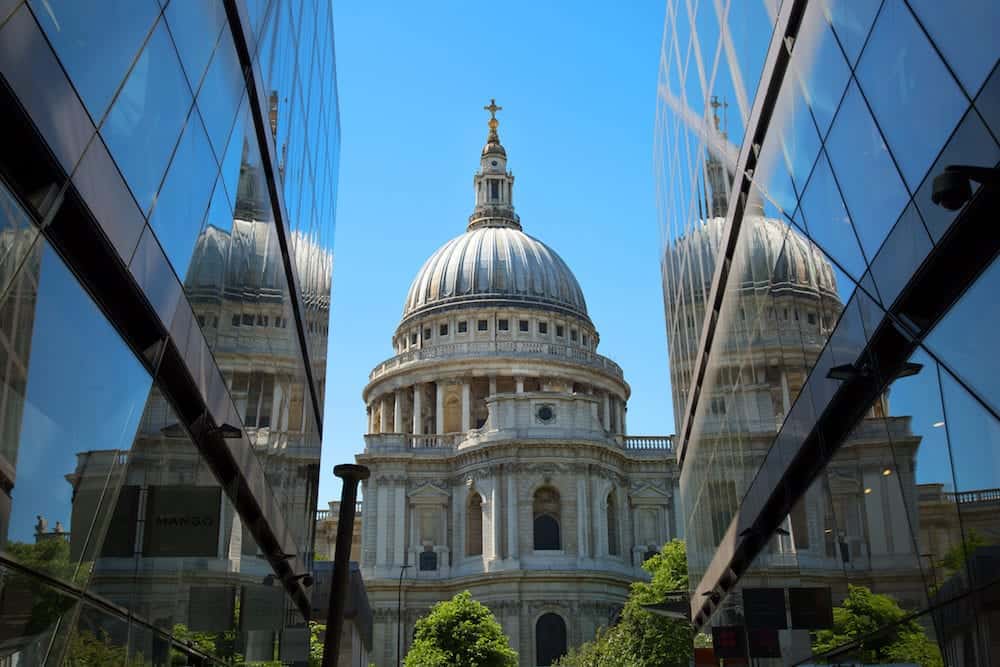 St-Paul's Cathedral and reflection in a mirror wall with a cloudy sky