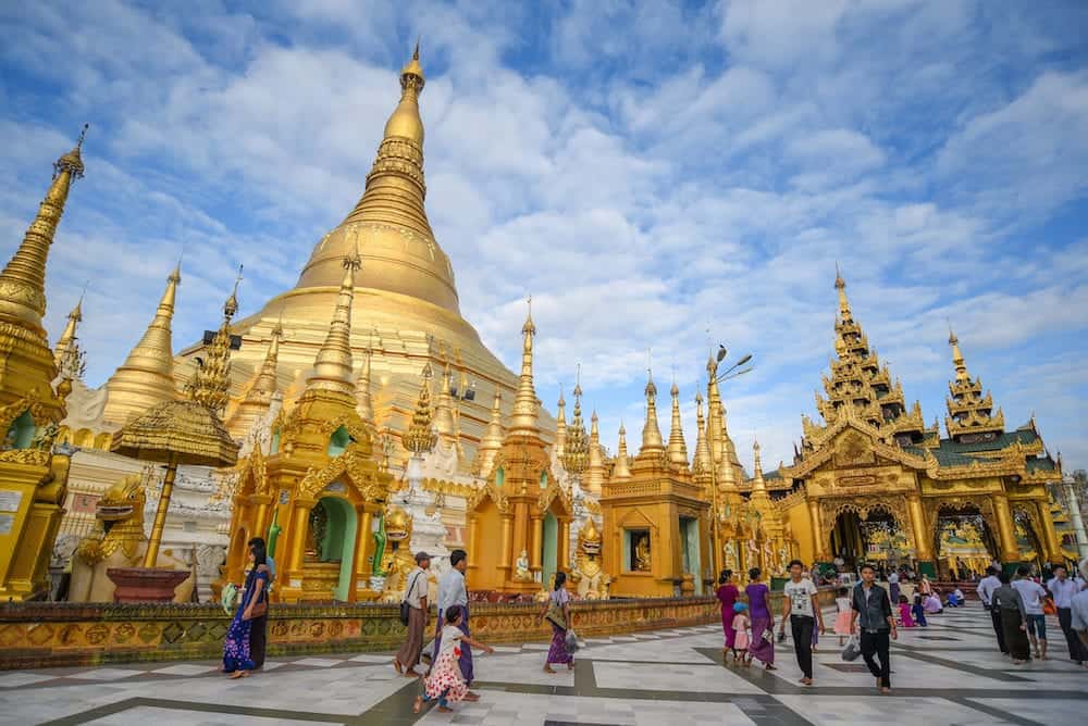 YANGON MYANMAR - Unidentified Burmese people walk inside the area of Shwedagon pagoda (Shwedagon Zedi Daw) famous landmark and travel destination of Yangon Myanmar.