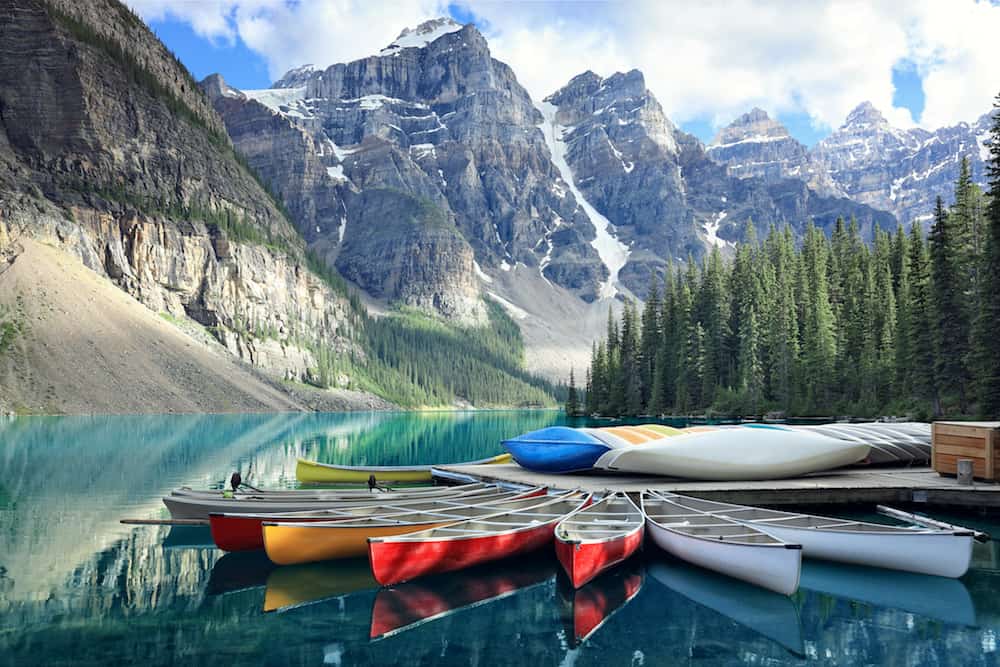 Canoes on a jetty at Moraine lake, Banff national park in the Rocky Mountains, Alberta, Canada