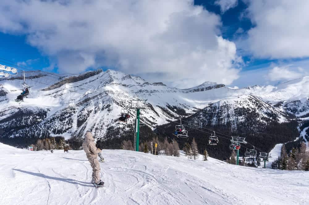 LAKE LOUISE CANADA -: Skiiers and snowboarders descend the slopes at Lake Louise. Lake Louise is a popular ski resort inside Banff National Park.