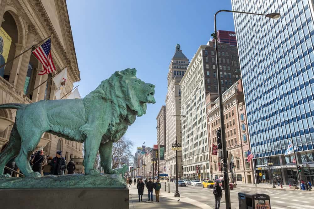 Chicago, USA - Bronze lion statue standing guard at the Art Institute of Chicago. There are two lion statues at the museum's Michigan Avenue entrance. They are famous Chicago landmarks and date to 1894.