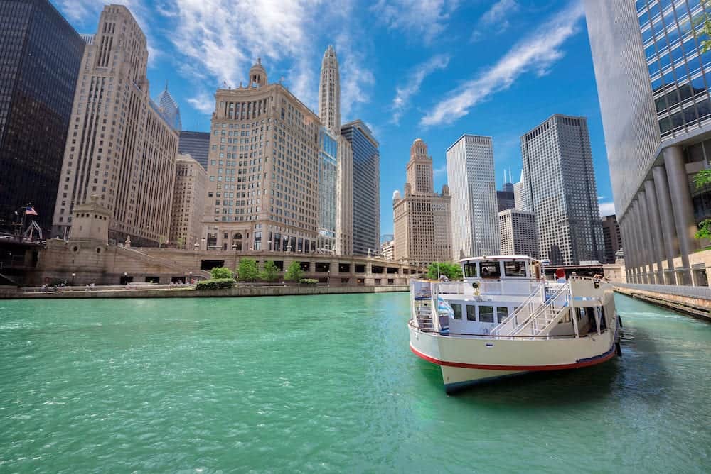 Chicago downtown and Chicago River with tourist ship during sunny day, Illinois, USA.