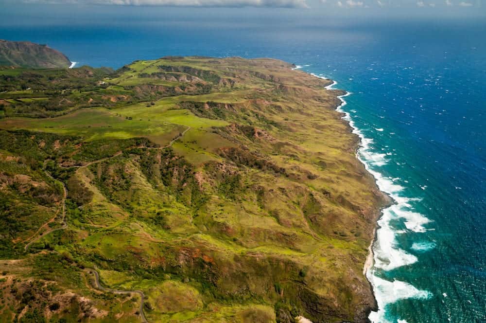 Aerial view of Molokai island coastline and lush hills