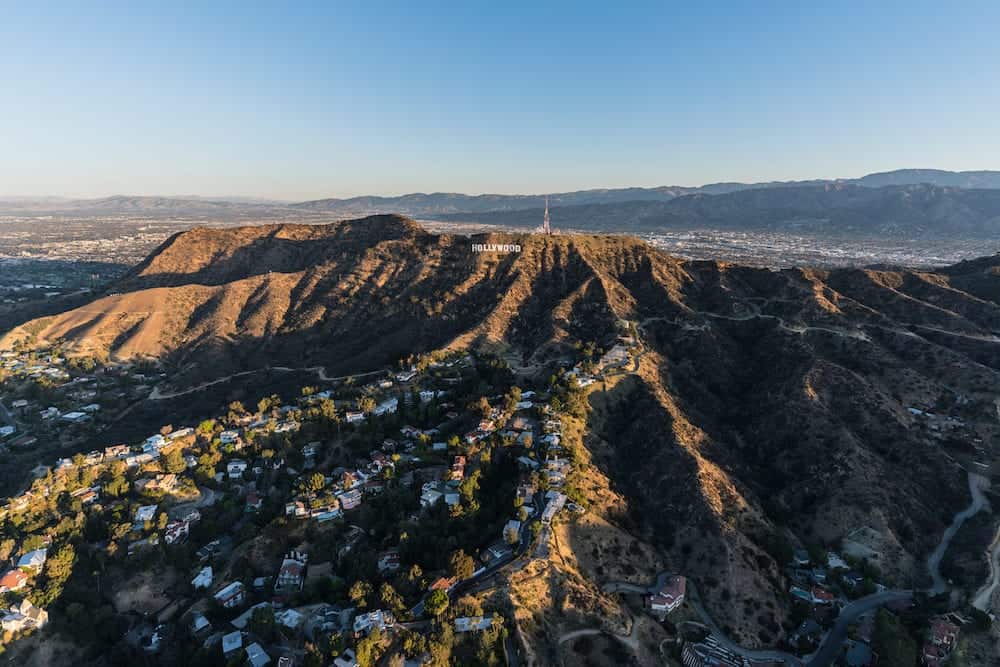 Los Angeles, California, USA : Morning aerial view of canyon homes and Hollywood Sign in Griffith Park with the San Fernando Valley in background.