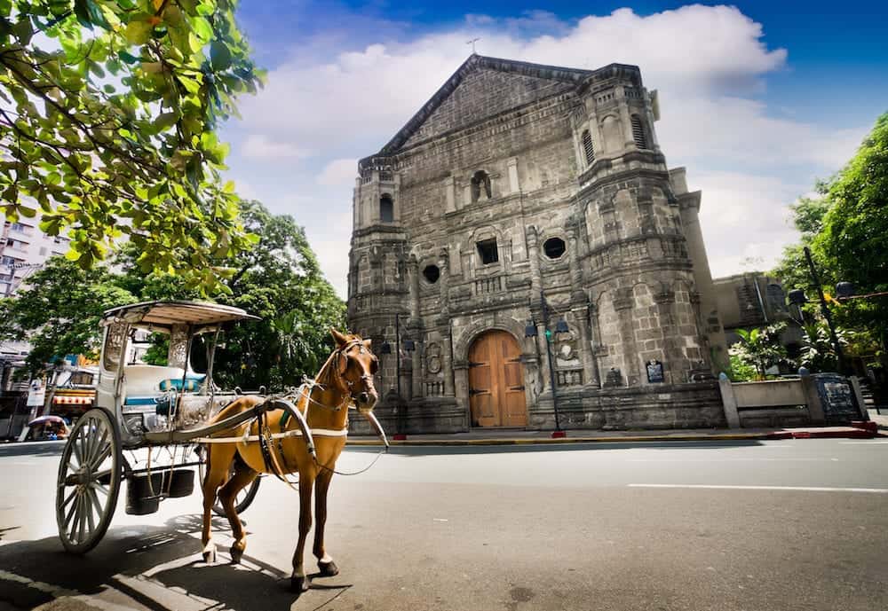 Horse Drawn Carriage parking in front of Malate church , this historical church is located in Intramuros the oldest district and historic core of Manila Philippines