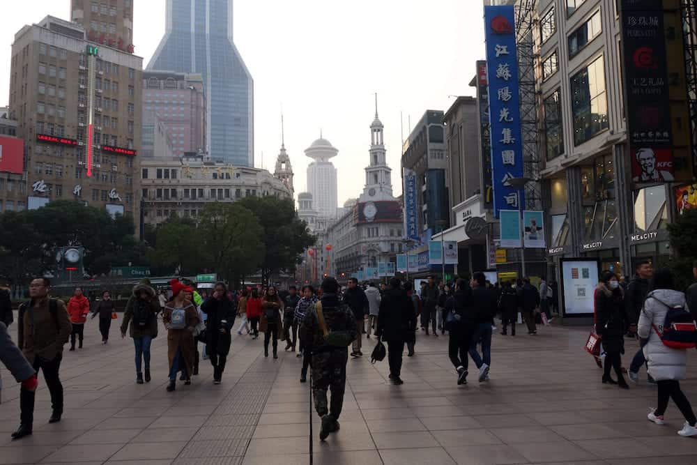 SHANGHAI, CHINA: People walking on the Nanjing Road Pedestrian Street in Shanghai, China. Nanjing Road is a unique pedestrian street with numerous old and famous shops, and modern department stores.