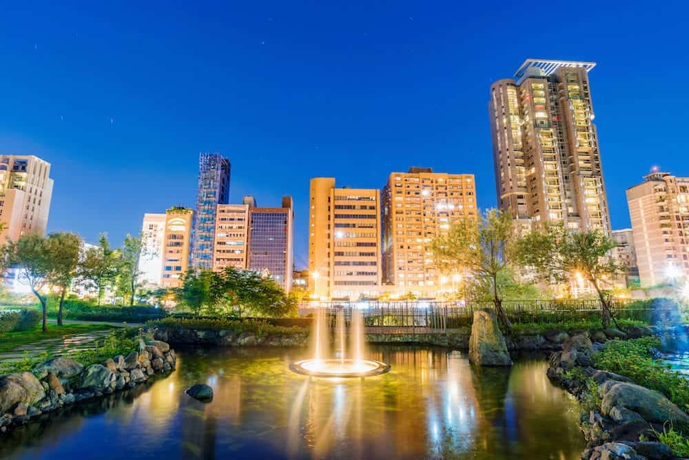 TAIPEI TAIWAN - This is a night view of Daan forest park nature with modern high rise city buildings in Taipei