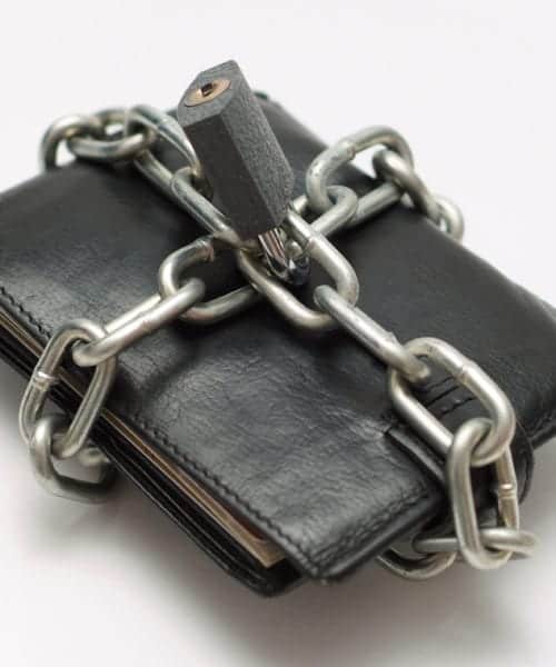 Locked wallet with chain and padlock save money concept