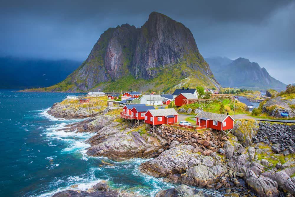 Norway, Lofoten islands. Spring day in Norway. Beautiful seascape of Lofoten islands. Red fishing houses on stone seaside.
