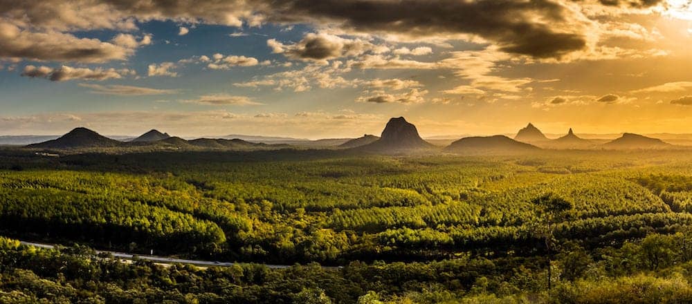 Panoramic view of Glass House Mountains at sunset visible from Wild Horse Mountain Lookout, Australia
