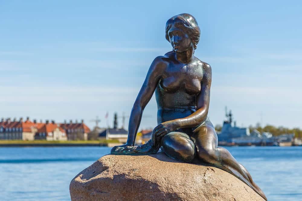 Copenhagen, Denmark- The Little Mermaid bronze statue depicting a mermaid. The sculpture is displayed on a rock by the waterside at the Langelinie promenade in Copenhagen.