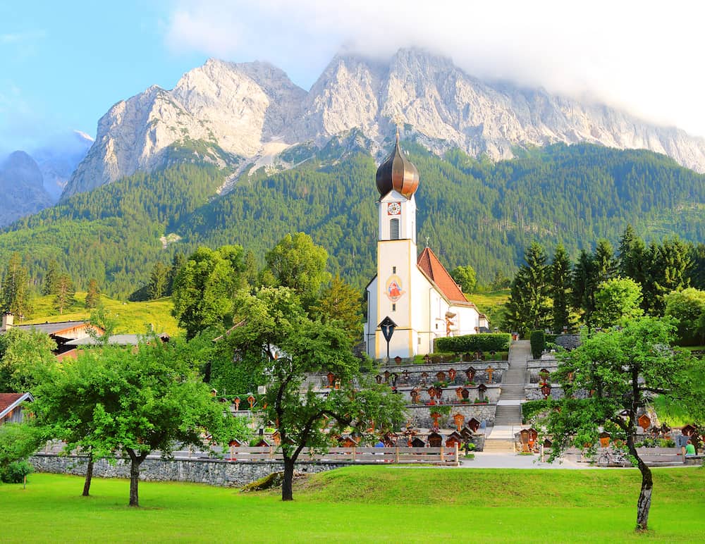 GARMISCH-PARTENKIRCHEN / GERMANY - : View of Grainau's church with the Zugspitze behind. It is Germany's highest peak (2962 m).