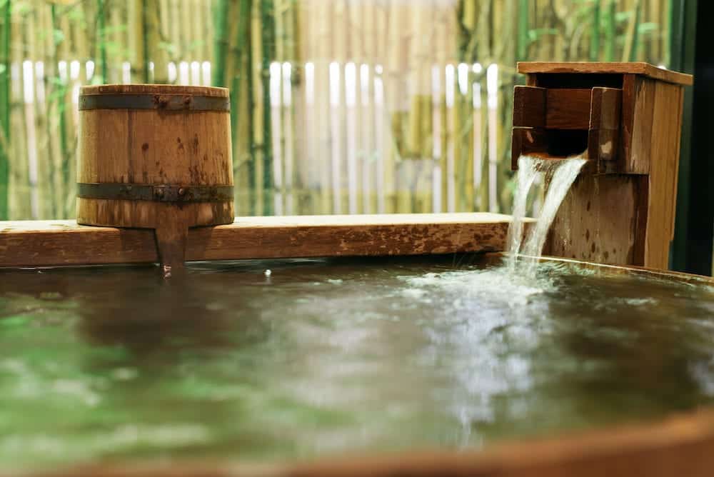 Onsen series: Water streaming into wooden bathtub