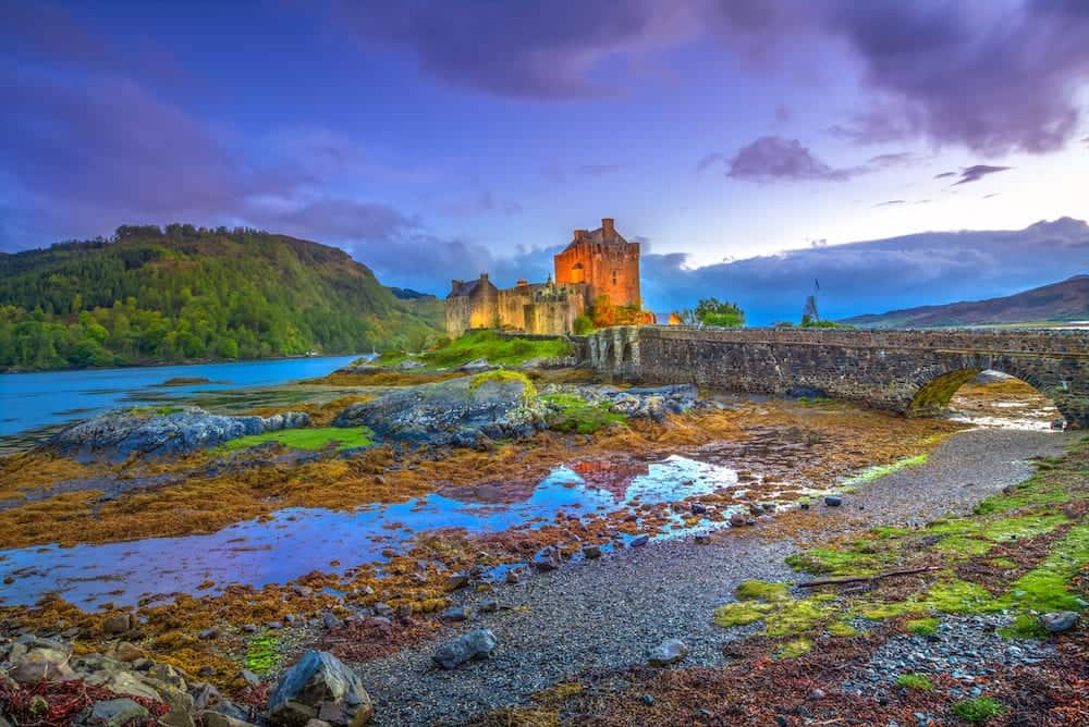 Blue hour twilight at Eilean Donan Castle, Dornie town, in Scotland, United Kingdom. A 13th Century Castle in the Highlands of Scotland.Eilean Donan Castle is the most visited castle in the UK.