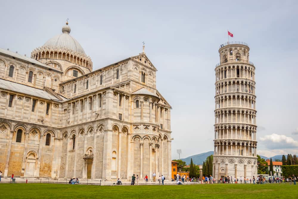 PISA, ITALY - Tourist sightseeing Pisa Cathedral, Roman Catholic cathedral dedicated to the Assumption of the Mary and the Leaning Tower of Pisa, bell tower of cathedral in Pisa, Italy.