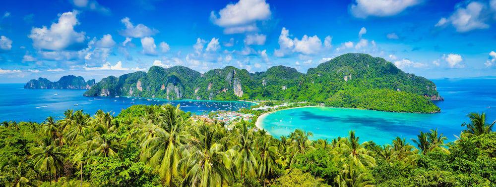 Thailand tropical vacation holidays concept background - panorama of tropical islands Phi Phi Don and Phi Phi Leh in sea. Crabi, Thailand