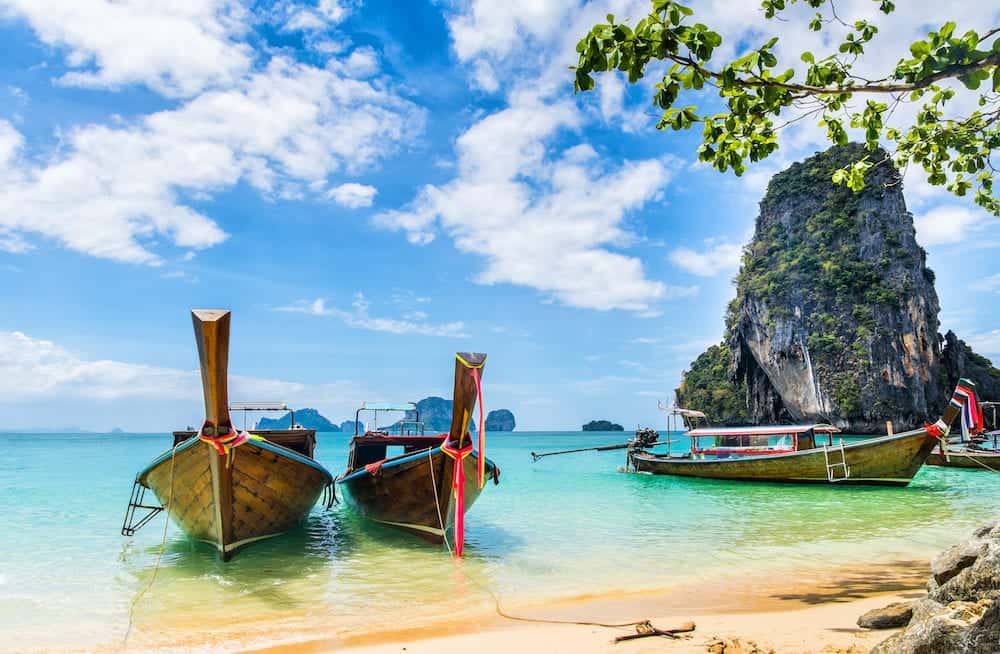 Amazing view of beautiful beach with longtale boats. Location: Railay beach, Krabi, Thailand, Andaman Sea. Artistic picture.