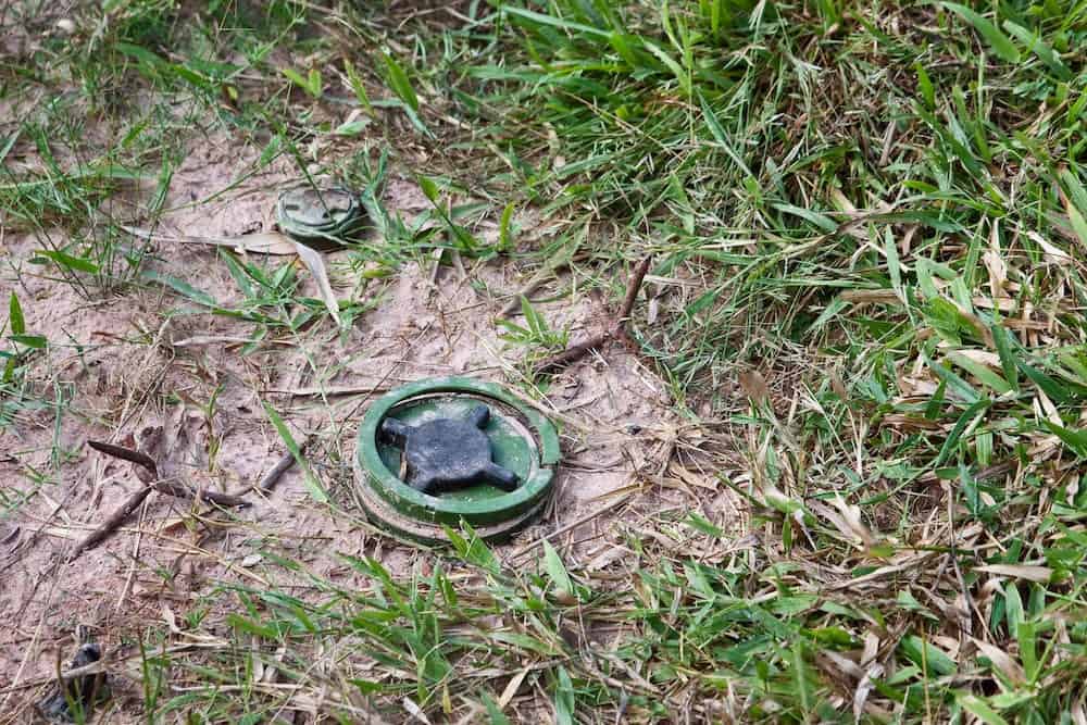 land-mine and spikes lie in a Cambodian field