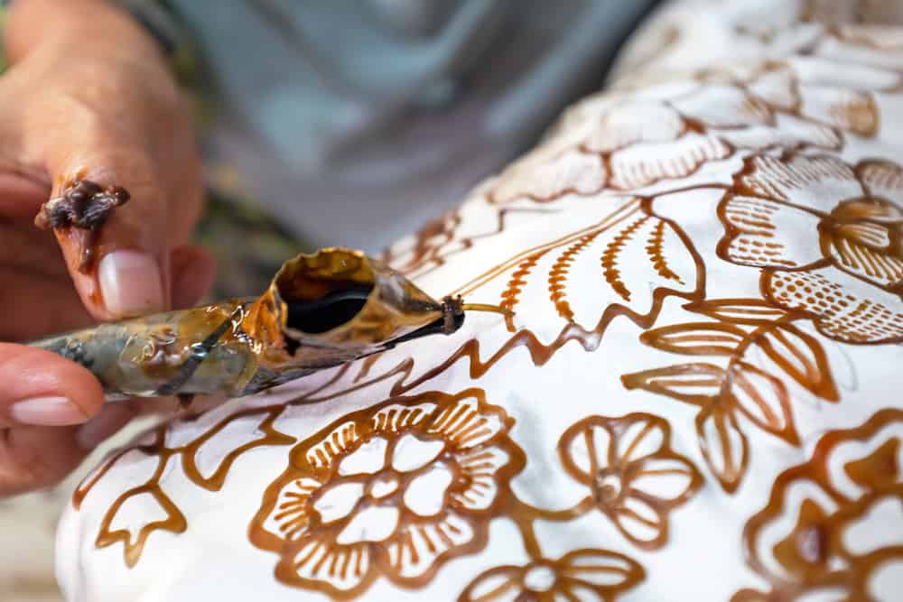 Painting watercolor on the fabric to make Batik Batik-making is part of Indonesian culture