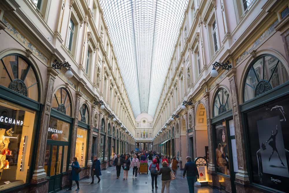 Brussels, Belgium - People shop in the historical Galeries Royales Saint-Hubert shopping arcades in Brussels