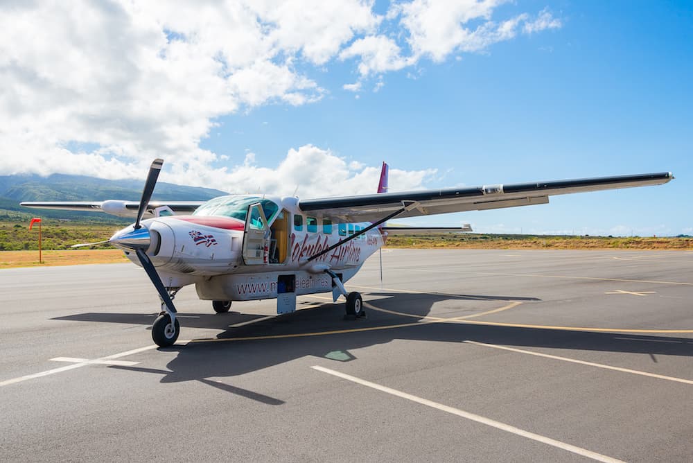 Small private jet standing alone in the airport on the island of Maui, Hawaii, getting ready to go to Honolulu city on Oahu island. 