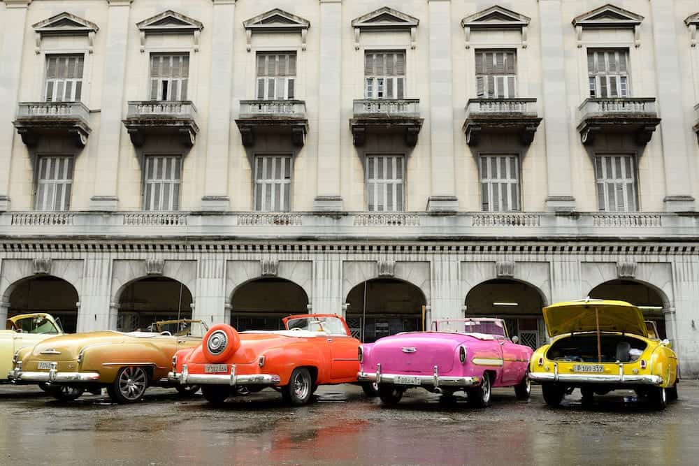 HAVANA, CUBA - : Old American colourful cars serving as taxis for tourists in order to go on a tour of old Havana standing in the Central Park in the heart of Havana