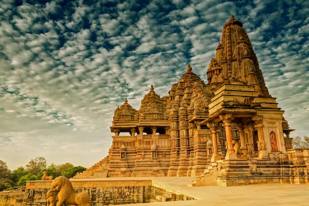 Beautiful image of Kandariya Mahadeva temple Khajuraho Madhyapradesh India with blue sky and fluffy clouds in the background It is worldwide famous ancient temples in India UNESCO world heritage site.