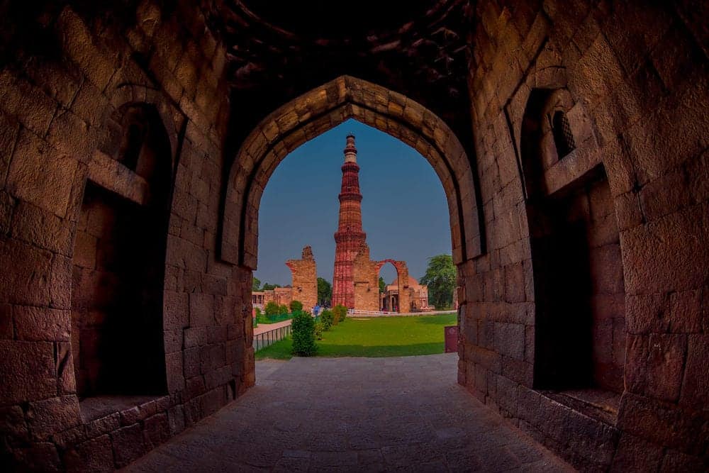 DELHI, INDIA - Beautiful view of Qutub Minar, through of a stoned arch, one of UNESCO world heritag site, built in the early 13th century located on south of Delhi, India.