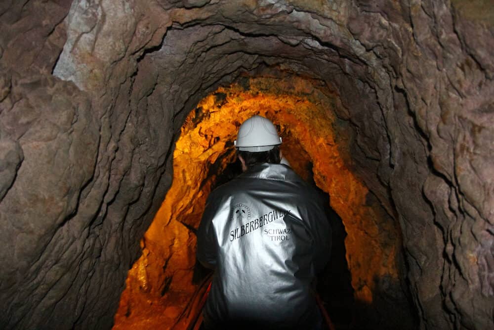Schwaz, Austria - : Tourists explore the mine using mini railway through the tunnel at the Silver Mine (Silberbergwerk Schwaz), the biggest silver mine of the Middle Ages