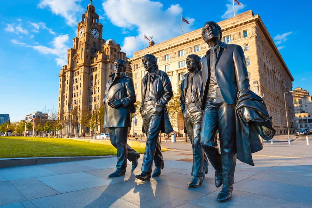 Liverpool, UK - Bronze statue of the Beatles stands at the Pier Head on the side of River Mersey, sculpted by Andrew Edwards and erected in December 2015