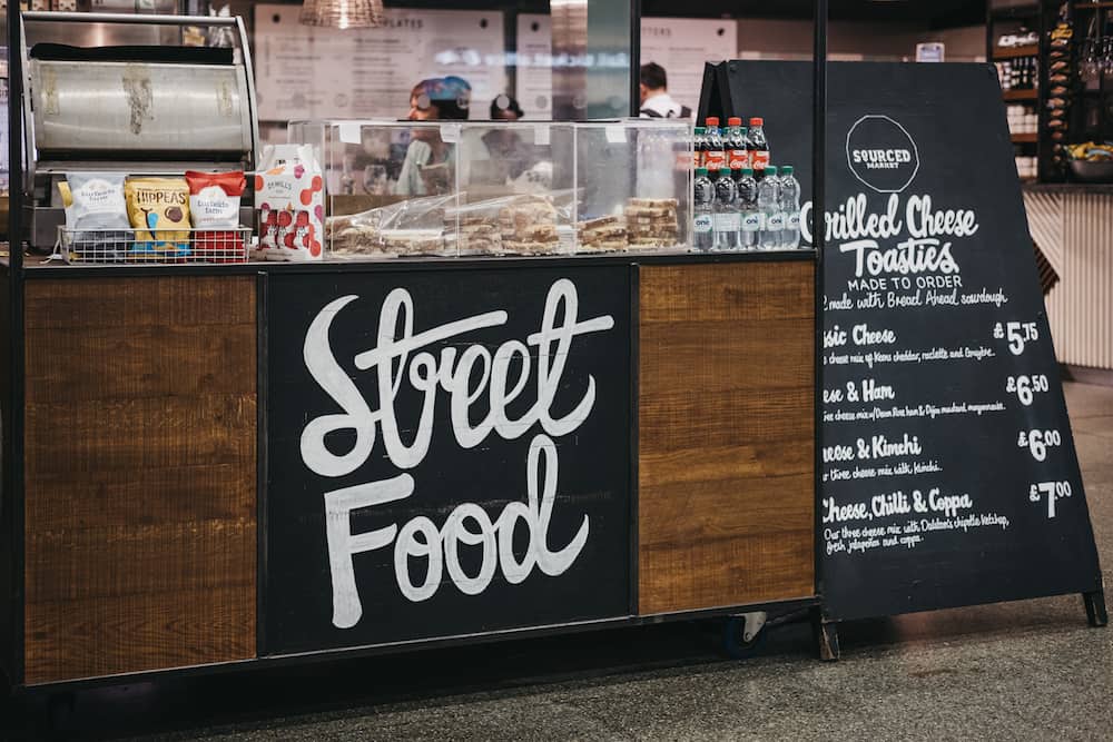 London, UK -: Street food stall inside St. Pancras station, one of the largest railway stations in London and home to Eurostar.