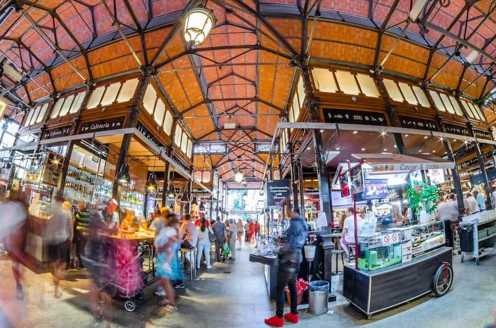 MADRID, SPAIN -: People visiting and enjoying drinks and tapas inside the historical "Mercado de San Miguel" (Market of San Miguel), popular among tourists, located in the center of Madrid, Spain