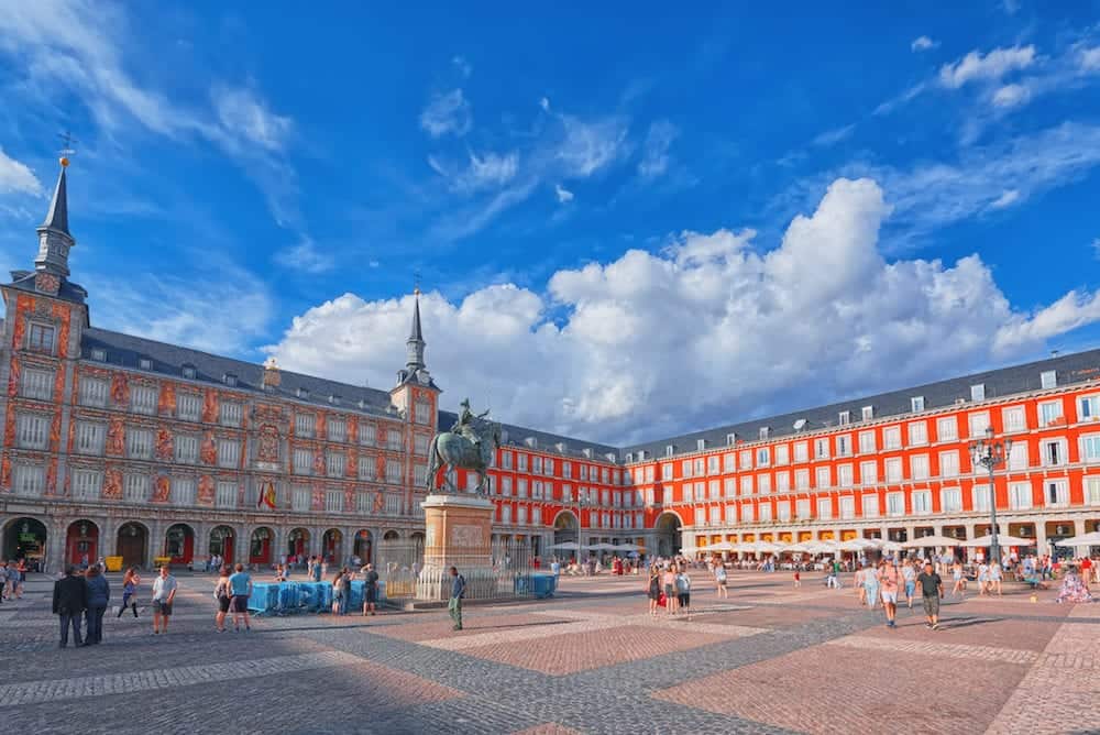 Madrid Spain- : Tourists on Plaza Mayor. Plaza Mayor - one of central squares of the Spanish capital. Located from another famous plaza- Puerta del Sol.