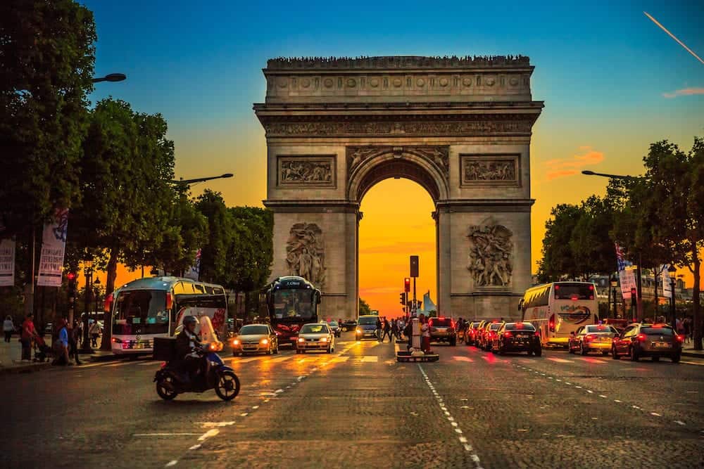 Paris, France -: square at Champs Elysees street and center of Place Charles de Gaulle with Arch of triumph at twilight with traffic street. Arc de Triomphe at blue hour in Paris.