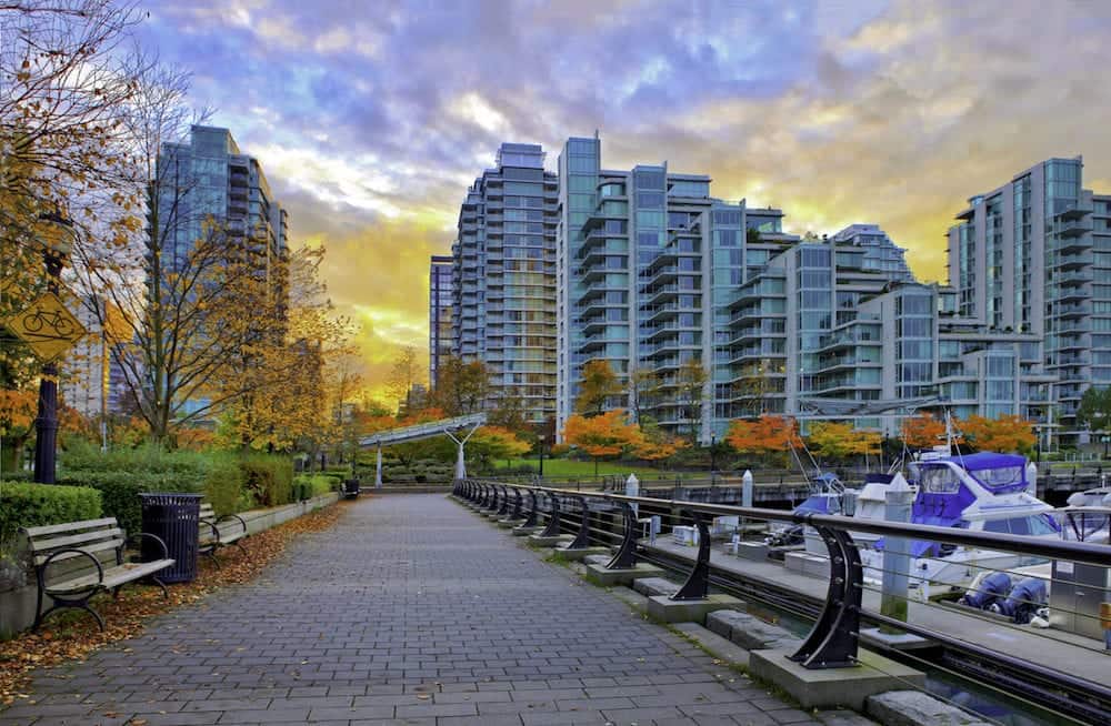 Paved pathway along Coal Harbour and modern residential buildings in the background. Vancouver Canada.