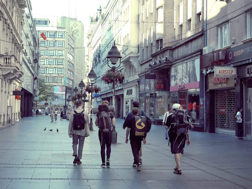 BELGRADE, SERBIA -: rear view young travelers with backpacks walking in central pedestrian street