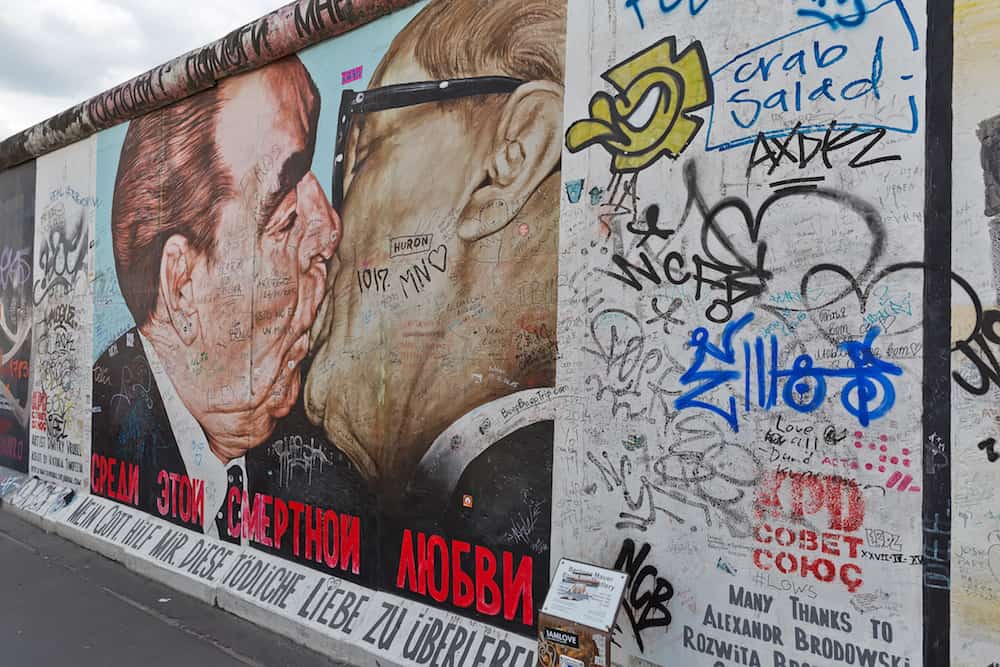 BERLIN GERMANY - Berlin Wall graffiti seen in Berlin East Side Gallery. It's a 1.3 km long part of original Berlin Wall which collapsed in 1989.