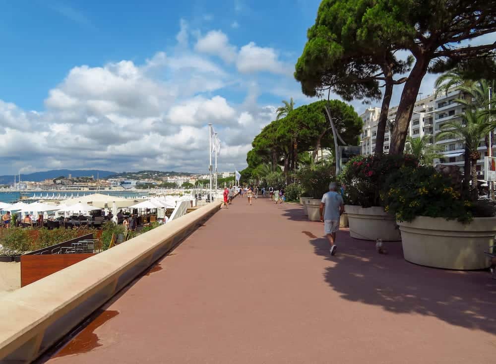 Cannes, France - Promenade de la Croisette in Cannes. France. Unidentified people are walking along the street.