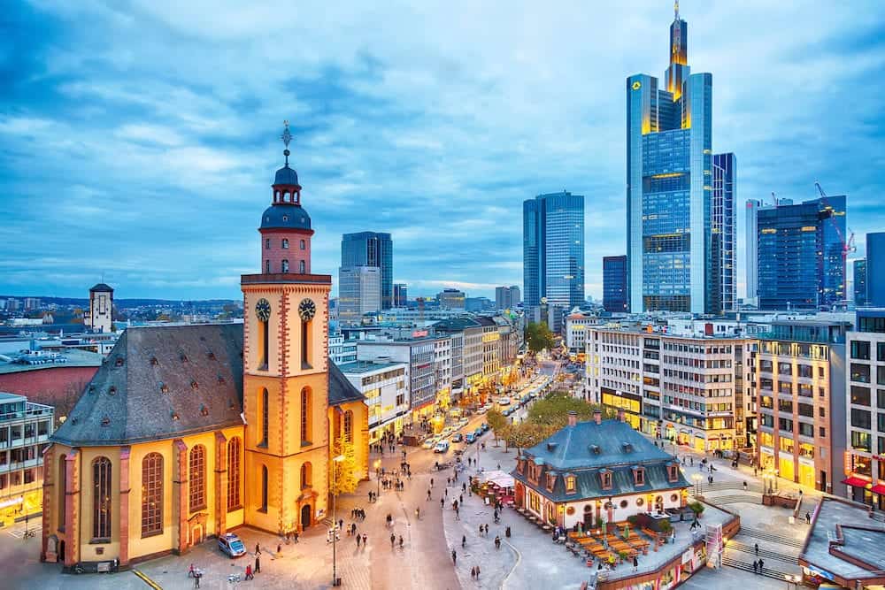 FRANKFURT GERMANY - View to skyline of Frankfurt in sunset blue hour. St Paul's Church and the Hauptwache Main Guard building at Frankfurt central street Zeil