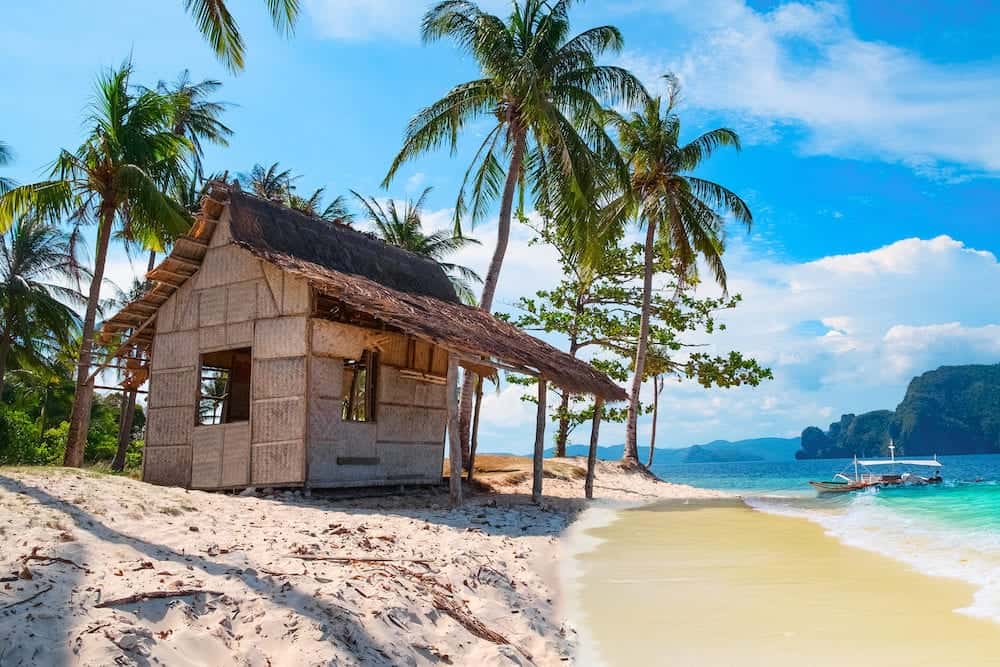 Scenic tropical landscape El Nido Palawan Philippines Southeast Asia. Beautiful tropical island with hut sandy beach palms. Sea bay scenery. Popular landmark tourist destination of Philippines