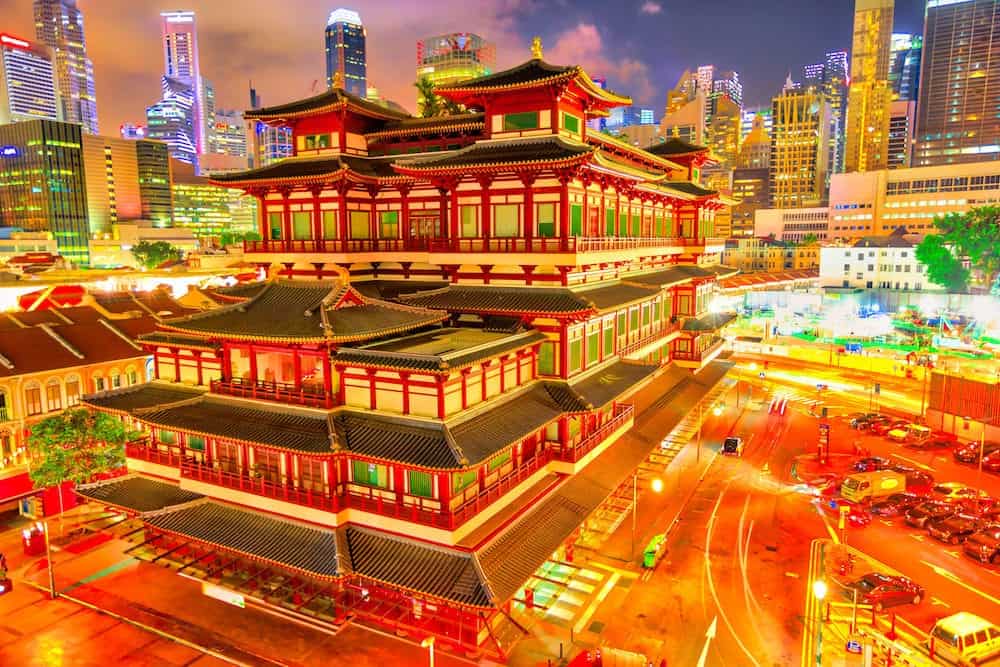 Buddha Tooth Relic Temple of Singapore from aerial view, Southeast Asia. Spectacular buddhist temple in Chinatown district with business district skyline on background by night.