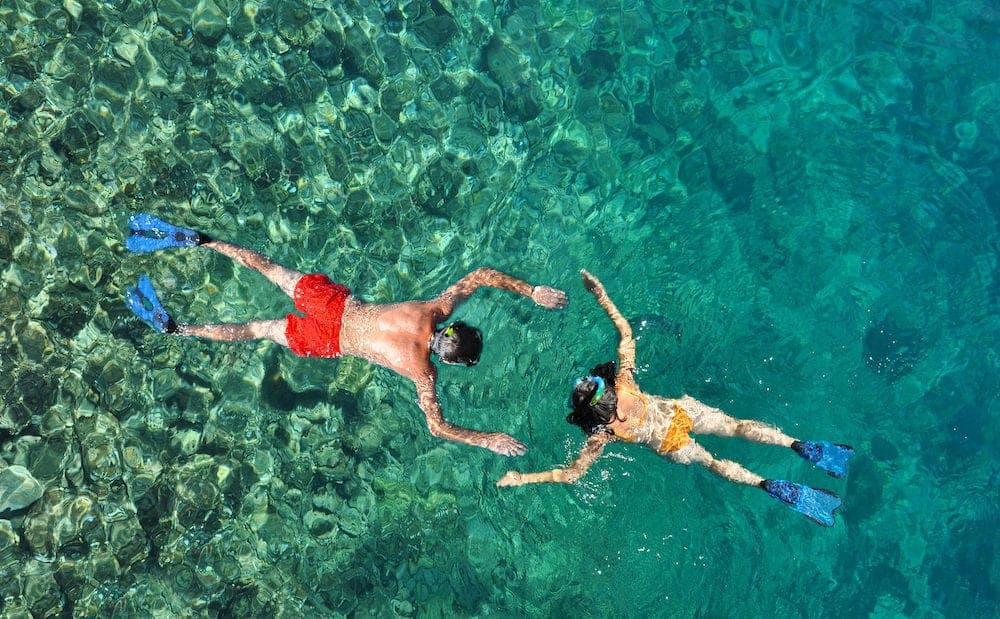 Romantic couple snorkeling in the sea in honeymoon